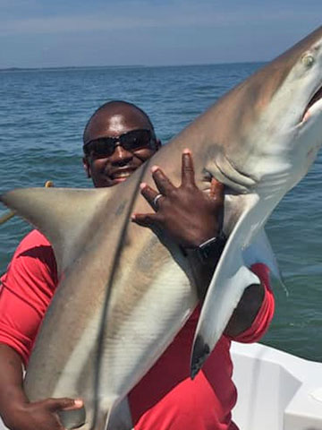 hiton-head-island-fishing-charter-man holding-shark